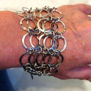 Buoux Turner multiple strands of linked silver hoops bracelet.